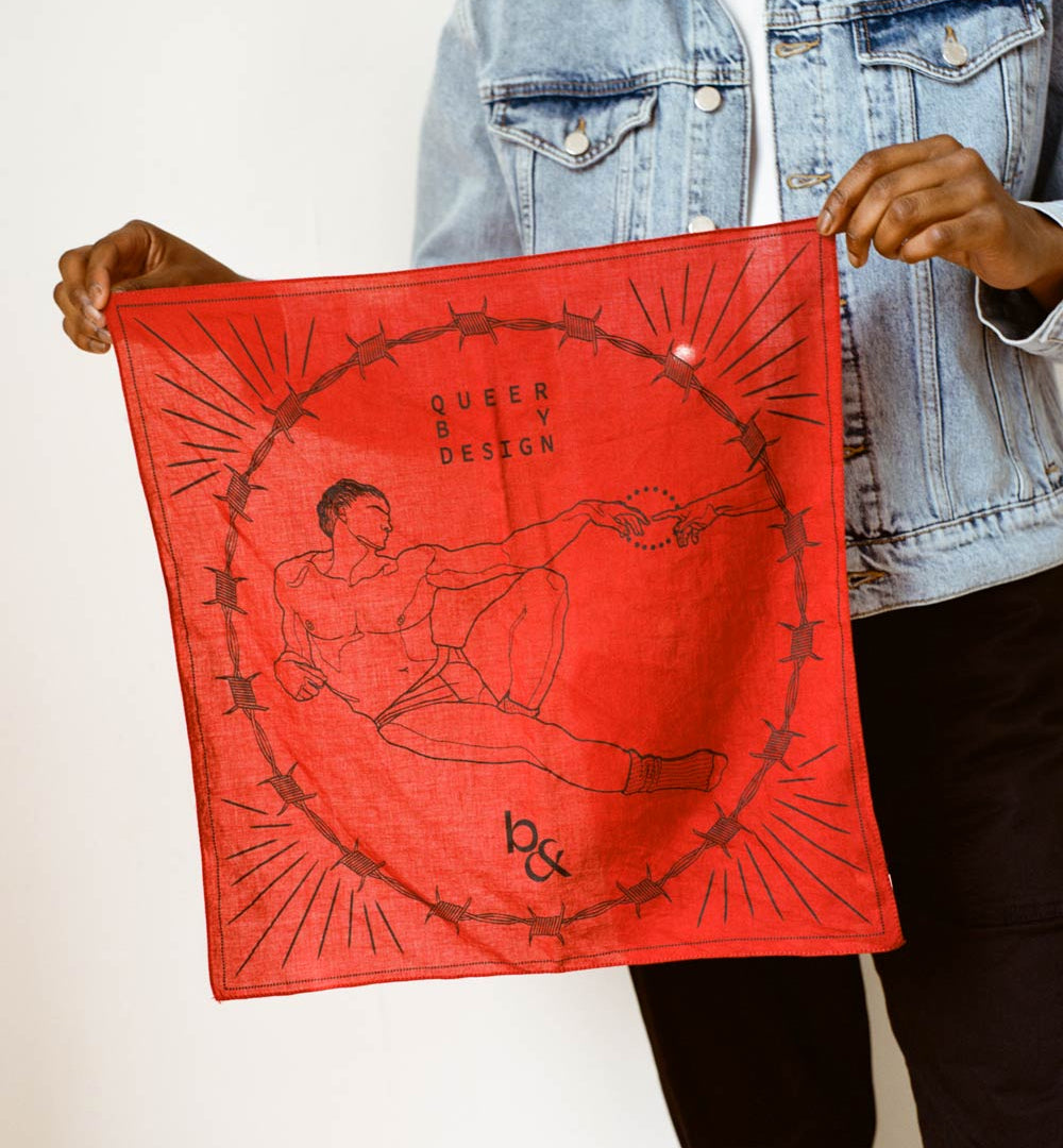 Person holding up a red Queer by Design bandana, with original artwork reinterpreting The Creation of Adam